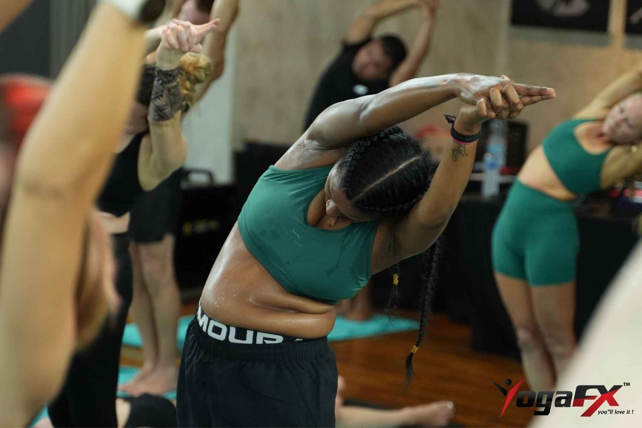 Practitioners doing the 26 and 2 original hot yoga sequence in a heated studio room.
