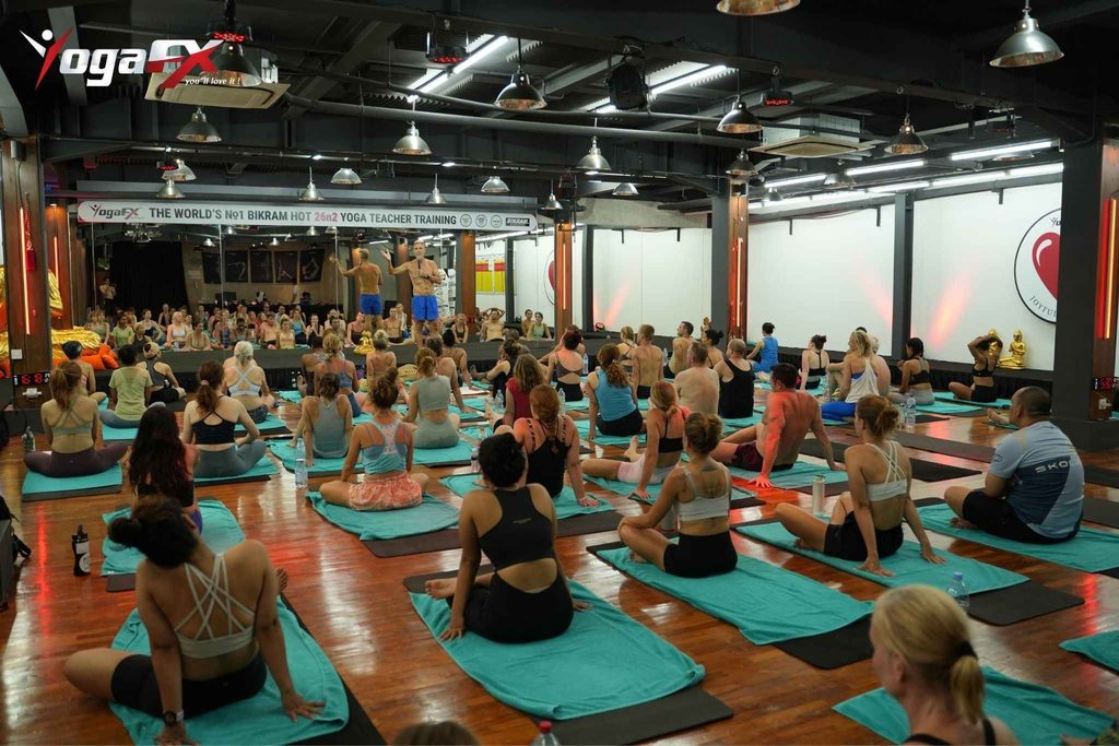 Participants in a professional 26&2 hot yoga teacher training course practicing mindfulness.