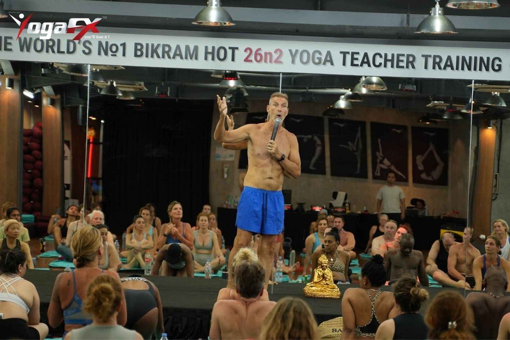 Teacher guiding a 26 and 2 yoga class through the spoken dialogue at a YogaFX studio in Bali, as taught in the teacher training