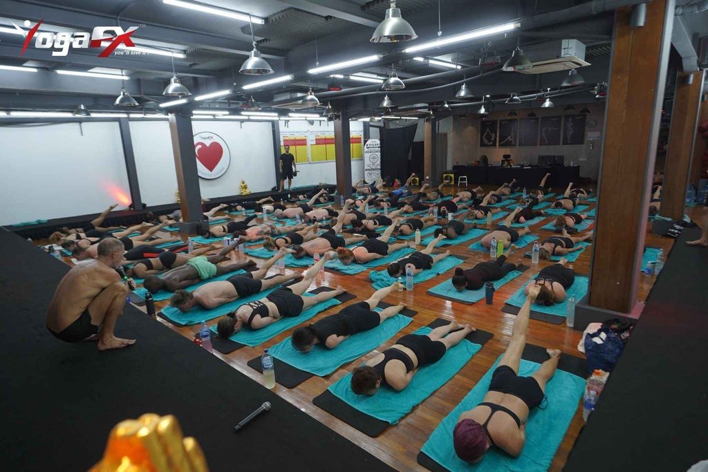 Home practice corner with yoga mat, towel and water bottle set up for hot yoga at home, ready for a 26 and 2 class in a warm room