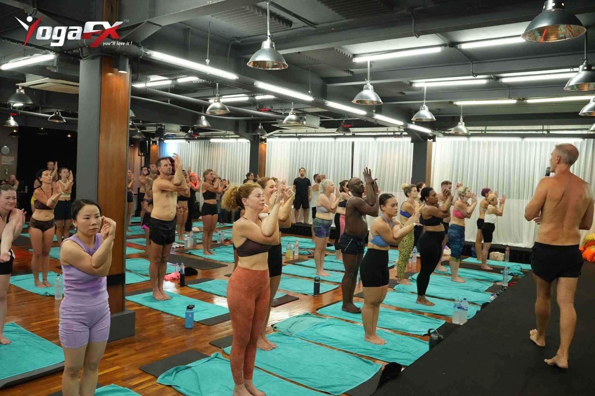 Water bottle and electrolytes beside a yoga mat, showing how athletes rehydrate after a hot yoga class used for CrossFit recovery